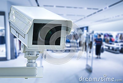 Cctv camera or security camera on retail shop blurred background Stock Photo