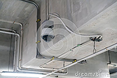 CCTV security camera installed on ceiling building. Stock Photo