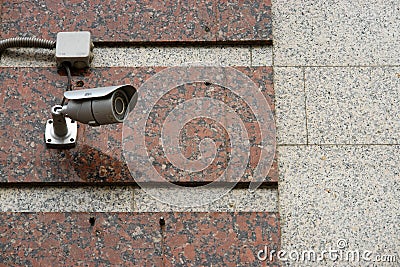 CCTV security camera on the wall outside. Stock Photo