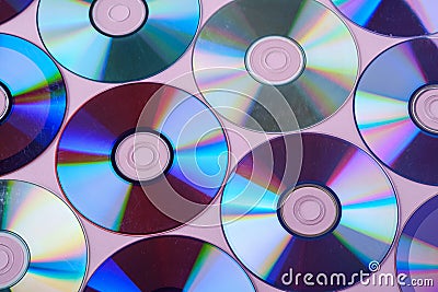 CD DVD compact disc disk dispersion refraction reflection of light colors texture on pink background Stock Photo