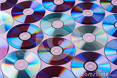 CD DVD compact disc disk dispersion refraction reflection of light colors texture on pink background Stock Photo