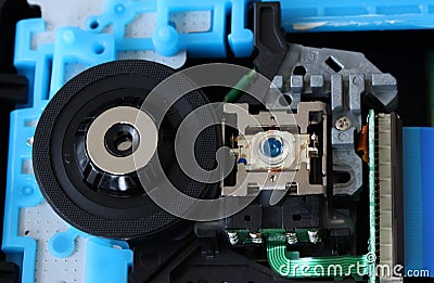 CD inside a DVD payer showing optical pick up laser lens with circuits, cables and boards - close up Stock Photo