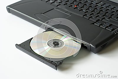 Cd in laptop disc drive Stock Photo
