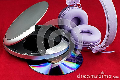 CD and CD Player and Headphones on a Red Background Stock Photo