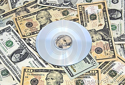 Cd-rom on pile of cash Stock Photo