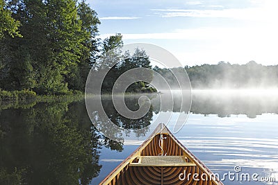 Cedar Canoe Bow on a Misty Lake Stock Photo