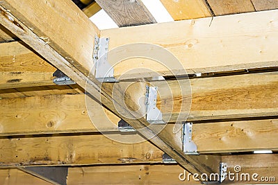 Ceiling beams - floors in a wooden frame house, metal fasteners Stock Photo