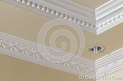 Ceiling decoration with plaster cast and embed lamp in ceiling panel. Eclectic interior design. Architectural detail. Stock Photo