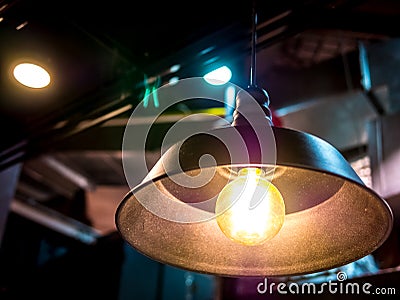 Ceiling lamp electric light in the dark room high contrast art abstract object background blur no people.Low angle view. Stock Photo