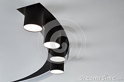 Ceiling lamp spotlight. Black spotlights on white ceiling. Modern lighting for a living room interior Stock Photo