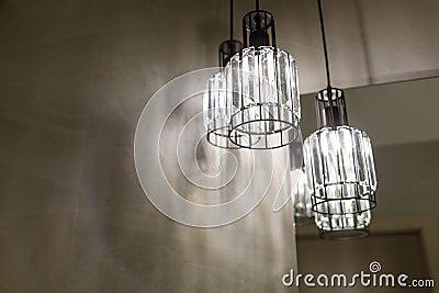 Ceiling light. Modern three-lamp chandelier. Lamp in the bathroom. Reflected in the mirror Stock Photo