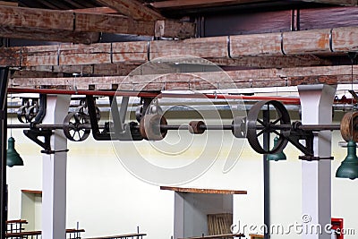 Ceiling mounted belts and pulleys in an old cotton processing factory Stock Photo
