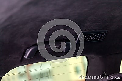 The ceiling of the SUV car pulled by black soft material alkantara in the workshop for tuning and styling the interior Stock Photo