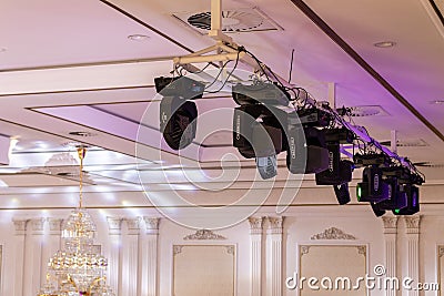 Ceiling truss with professional lighting equipment in the form of a beam head and light wash in the event hall Editorial Stock Photo