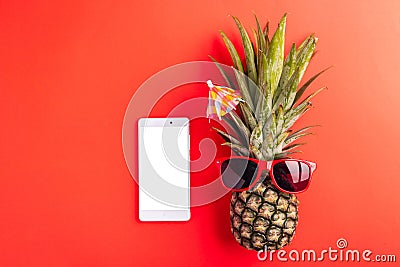 Celebrate Summer Pineapple Day Concept, Top view of funny pineapple wear red sunglasses and smartphone blank screen, isolated Stock Photo