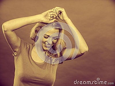 Happy positive blonde woman gesturing hands Stock Photo