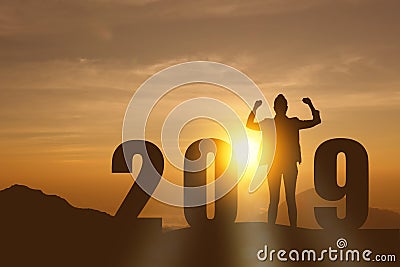 Celebrating new year 2019 Silhouette freedom young hope business woman standing and enjoying on the the top of the mountain, hill Stock Photo