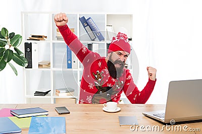 Celebrating success. Businessman in Christmas jumper make winner gesture. Happy hipster celebrate success in office Stock Photo