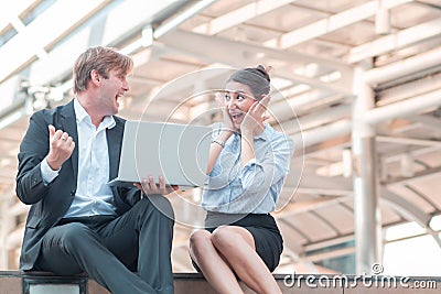 Celebrating success.Excited cheerful young business couple Looking at each other with extreme joy After knowing the success of Stock Photo
