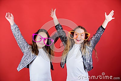 Celebrating together. Party girls. Cool party girls wearing fancy glasses. Small kids in party goggles having fun. Happy Stock Photo