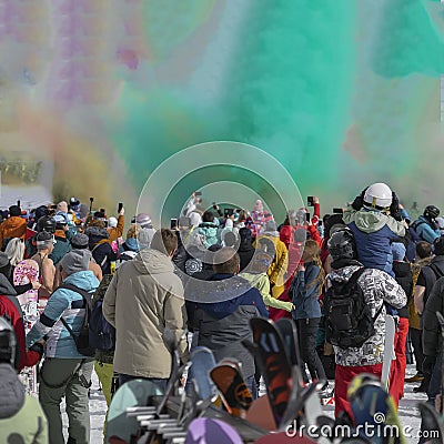 Celebrating winter Holi festival. Colorful powder explosion. Silhouettes of unrecognizable people back to us shooting Editorial Stock Photo