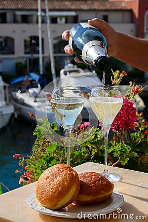 Celebration with champagne sparkling wine and french stuffed with apples or chocolate beignets donuts pastry, sweet dessert served Stock Photo