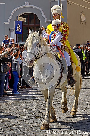 Man and child on the horse, in traditional national costumes at the parade - Celebration Days of Brasov City, landmark in Romania Editorial Stock Photo