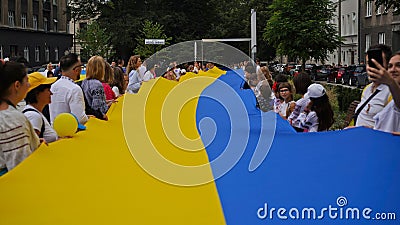Celebration of Independence Day of Ukraine,National Flag Day,Constitution Day.People unfurled huge blue-yellow flag on August 24. Editorial Stock Photo