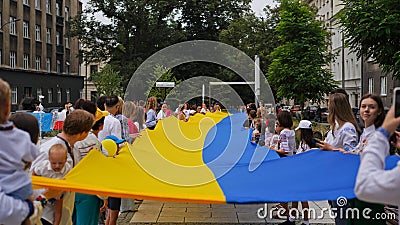 Celebration of Independence Day of Ukraine,National Flag Day,Constitution Day.People unfurled huge blue-yellow flag on August 24. Editorial Stock Photo