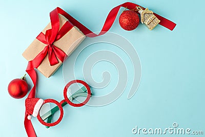 Celebration, party backgrounds concept for winter holiday paty - gift box, party stuff, decorative toy balls on blue background, c Stock Photo