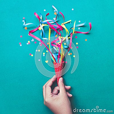 Celebration,party backgrounds concepts ideas with hand holding colorful confetti,streamers. Stock Photo