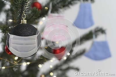 Celebration with social issuse virus corona or covid 19 concept. Christmas tree ornament with protective face mask Stock Photo