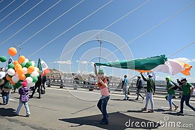 A celebratory parade in honor of the first Maya. people walk on the bridge Editorial Stock Photo