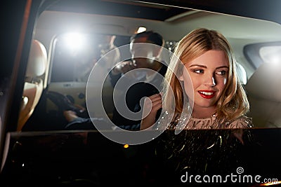 Celebrity couple in back of a car, photographed by paparazzi Stock Photo