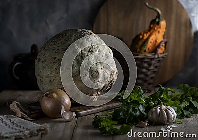Celery root, onion, parsley, garlic and pumpkin on a wooden table Stock Photo