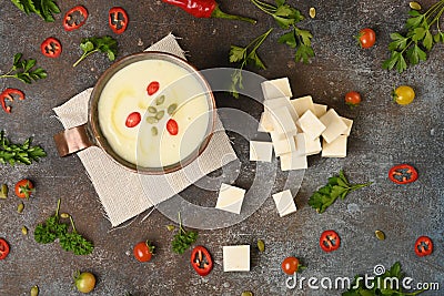 Celery root soup in copper cup on dark background. Stock Photo