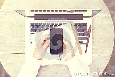Cell phone with blank screen in man hands and laptop with diary Stock Photo