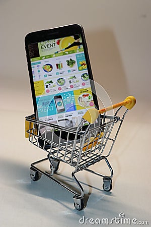 The cell phone is in a shopping cart Editorial Stock Photo