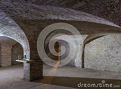 Cellar room with curved ceilings and a shaft of light coming through the entrance. Editorial Stock Photo