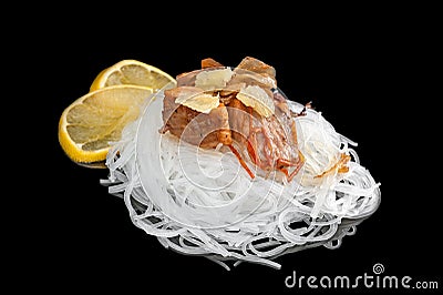 The cellophane with a piece of roasted salmon with tomatoes, onion and parsley isolated on black background Stock Photo