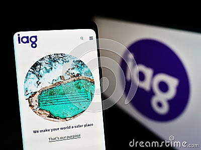 Cellphone with business website of company Insurance Australia Group Limited (IAG) on screen in front of logo. Editorial Stock Photo