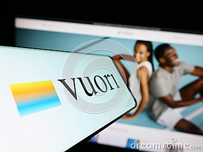 Cellphone with logo of American apparel e-commerce company Vuori Inc. on screen in front of website. Editorial Stock Photo