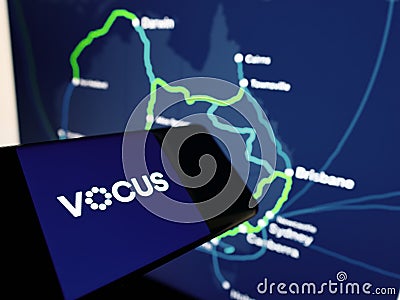 Cellphone with logo of Australian telecommunications provider Vocus Group Ltd on screen in front of website. Editorial Stock Photo