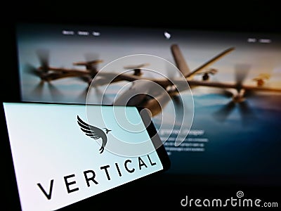 Cellphone with logo of British aircraft company Vertical Aerospace Ltd. on screen in front of website. Editorial Stock Photo