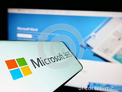 Cellphone with logo of productivity software Microsoft 365 on screen in front of company website. Editorial Stock Photo