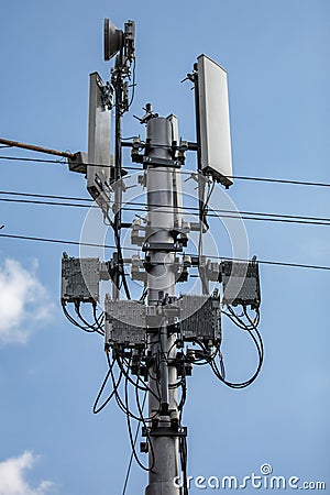 Cellular signal repeater under a blue cloudy sky Stock Photo