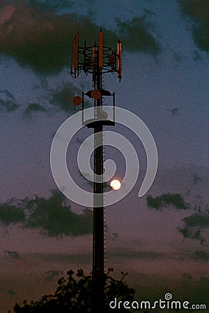 Cellular tower and Sunset. Equipment for relaying cellular and mobile signal. Stock Photo