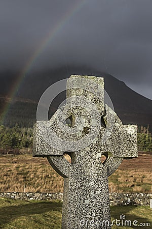 Celtic Cross and Rainbow on the Isle of Skye in Scotland. Stock Photo