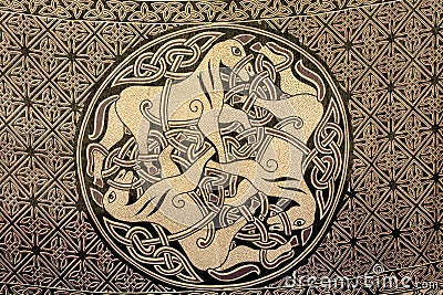 Celtic ornament of three horses on the fabric. Ancient symbol of Stock Photo