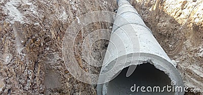 Cement pipe in soil trench Stock Photo